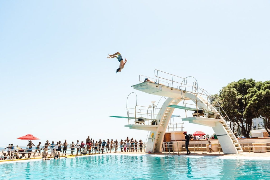 Boy doing backflip at blue Sea Point pools in cape town
