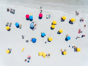 Aerial topdown of people tanning and umbrellas on Camps Bay beach