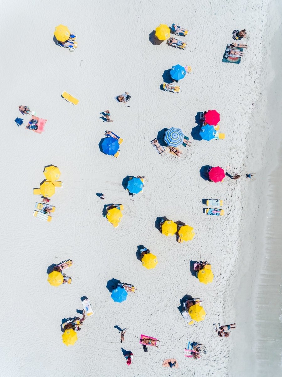 Aerial topdown of people tanning and umbrellas on Camps Bay beach