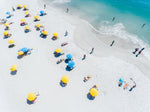 Blue and yellow umbrellas on Camps Bay beach Cape Town from above