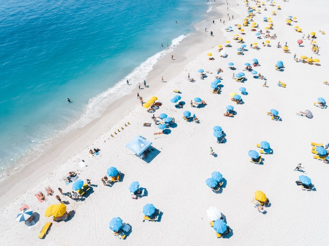 Blue and yellow umbrellas from above on summer day in cape town