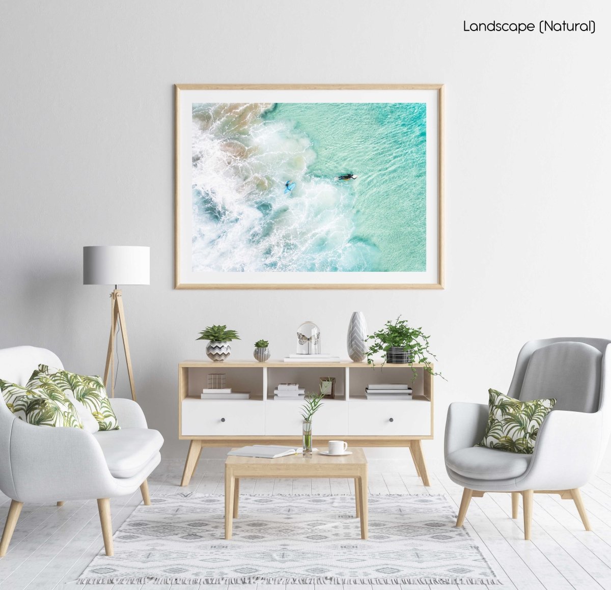Aerial view of two surfers paddling in turquoise water and foam in a natural fine art frame