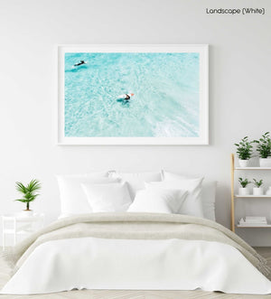 Surfers from above in light blue water in Cape Town in a white fine art frame