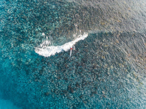 Aerial of kayak surfing on a shallow wave at Bower in Manly Sydney