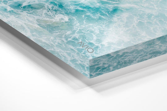 Light blue surfer paddling through foam from above in an acrylic/perspex frame