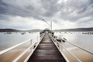 Moody clouds rolling towards boats and boardwalk in Sydney