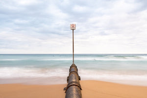 No diving sign and pipe in sea at Manly Beach NSW