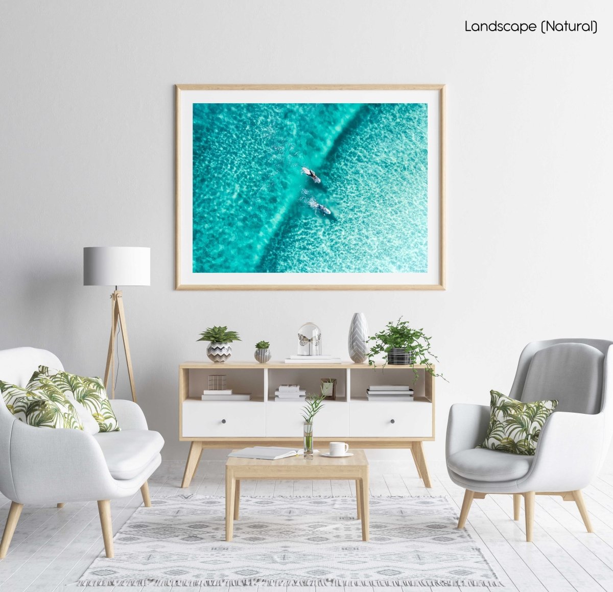 Two surfers paddling on one blue wave from aerial view in a natural fine art frame