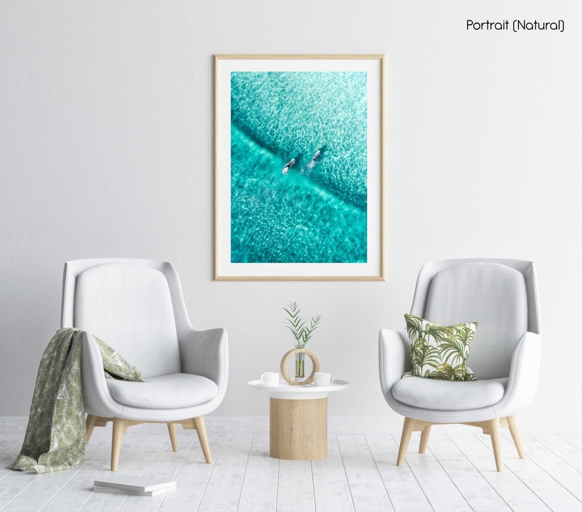 Two surfers paddling on one blue wave from aerial view in a natural fine art frame