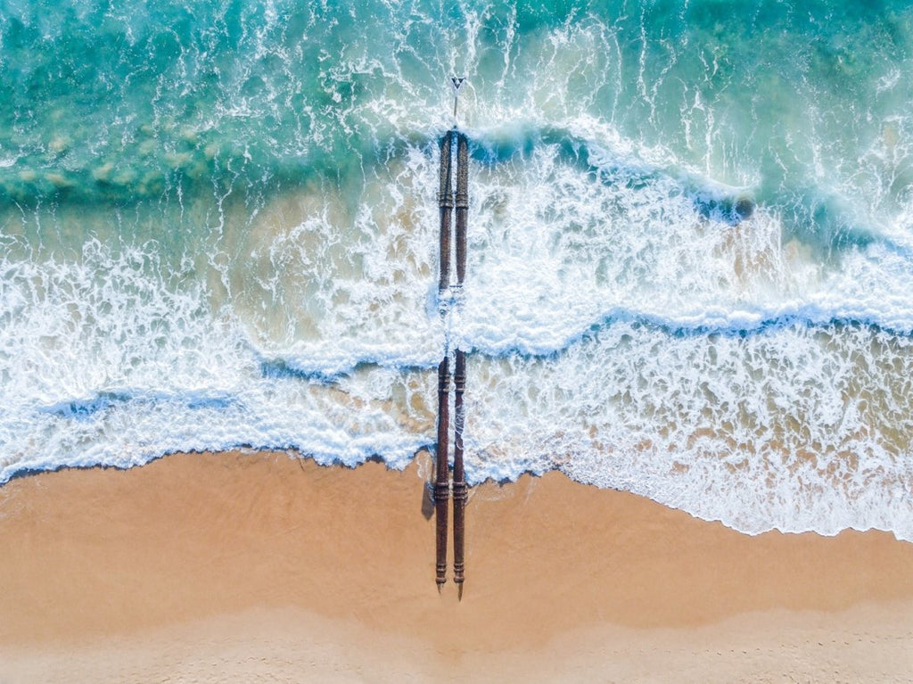 Aerial of beach pipes in ocean waves on Manly Beach Sydney