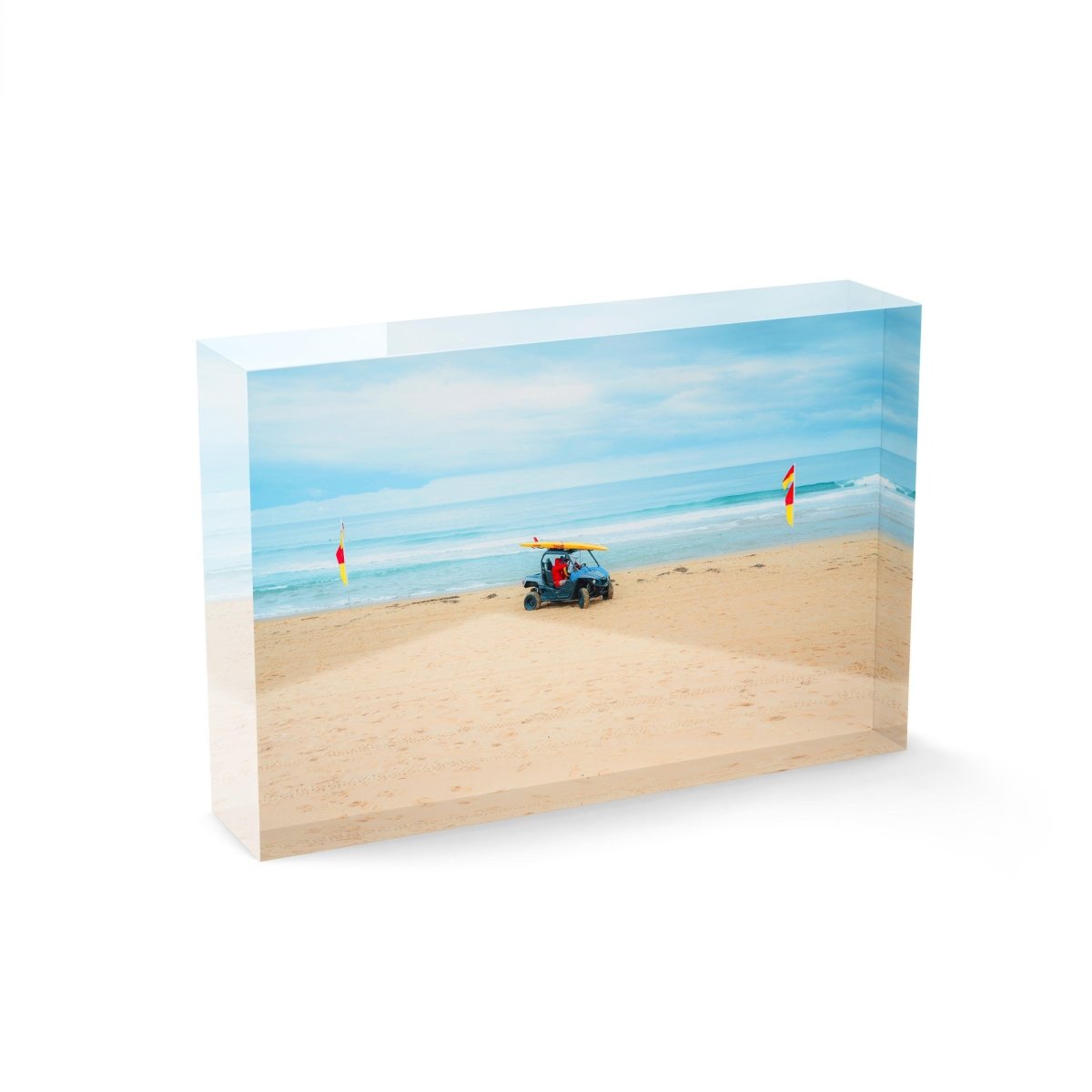 Lifesavers in a blue beach buggy with yellow board on roof in Monavale Beach Sydney