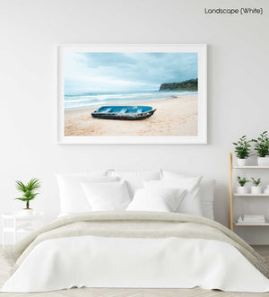 Stranded blue boat on northern beaches on cloudy day in a white fine art frame