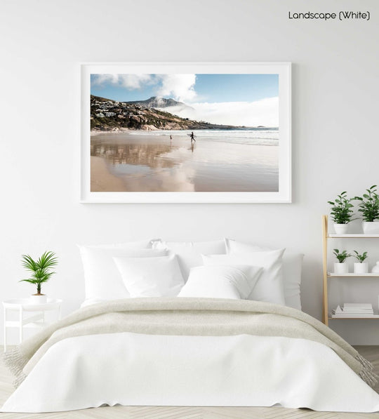 Surfer walking towards a kid on Llandudno Beach in Cape Town in a white fine art frame