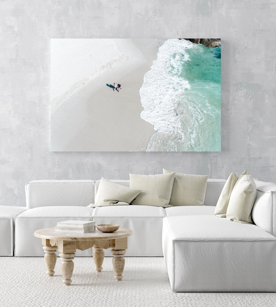 Aerial of a couple holding hands walking along Clifton Beach in Cape Town in an acrylic/perspex frame