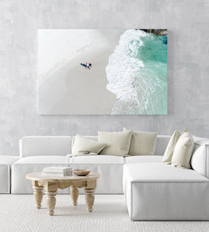 Aerial of a couple holding hands walking along Clifton Beach in Cape Town in an acrylic/perspex frame