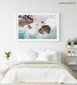 Girl standing among boulders on Clifton beach from above in a white fine art frame