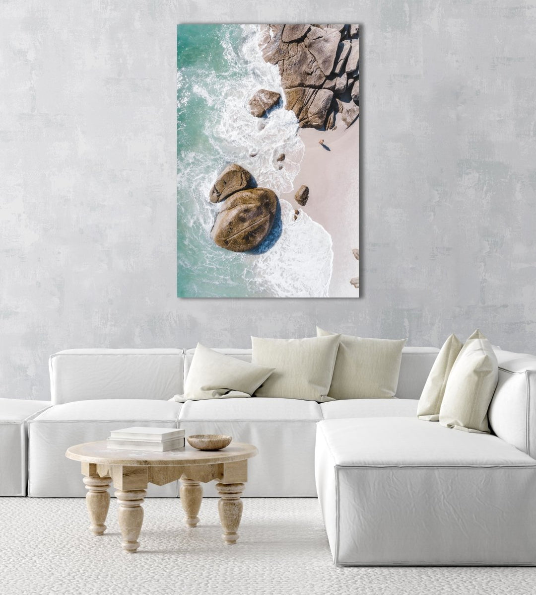 Girl standing among boulders on Clifton beach from above in a natural fine art frame