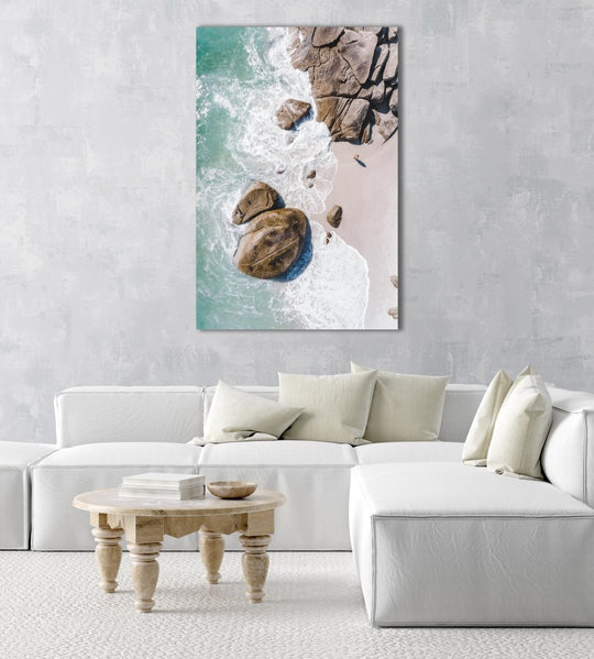 Girl standing among boulders on Clifton beach from above in a natural fine art frame