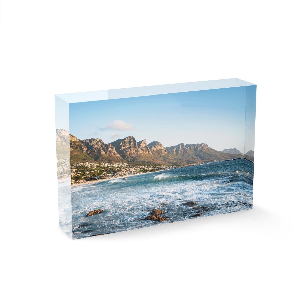 Windy offshore wave at Camps Bay Beach with Twelve Apostles mountains