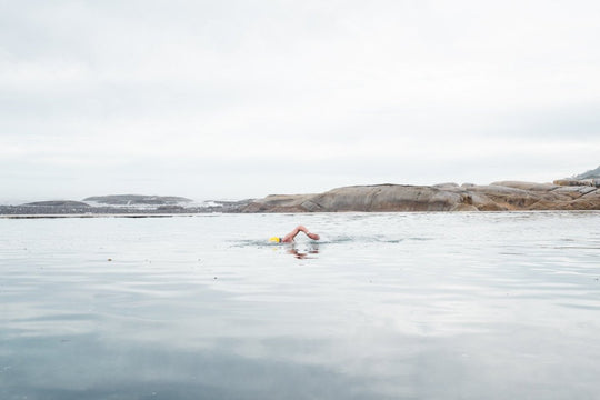 Man with yellow cap swimming in Camps Bay tidal pool