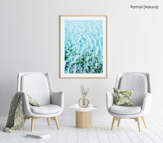 Blue ocean and seaweed with light shining on it in a natural fine art frame