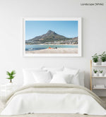Old man lying on rock at Camps Bay beach below lions head in a white fine art frame