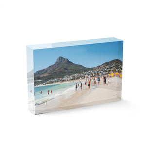 People swimming and playing on Camps Bay Beach below the lions head