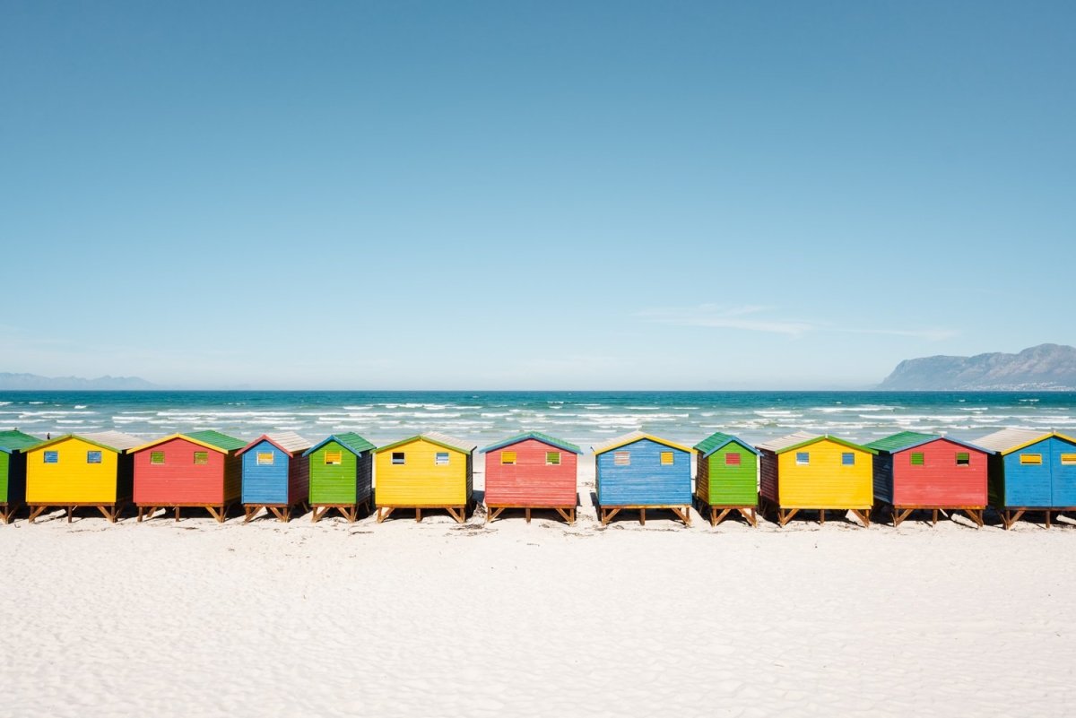 A row of colorful huts along Muizenberg Beach