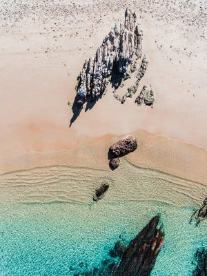 Aerial of a jagged rock along Kalk Bay coast