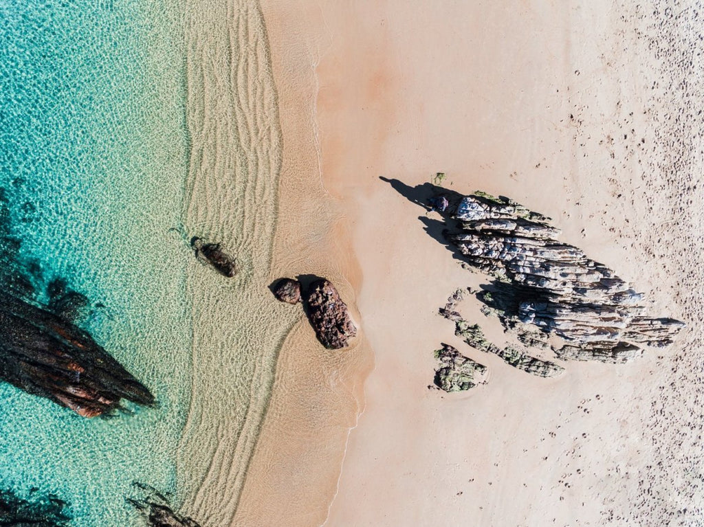 Aerial of a jagged rock along Kalk Bay coast