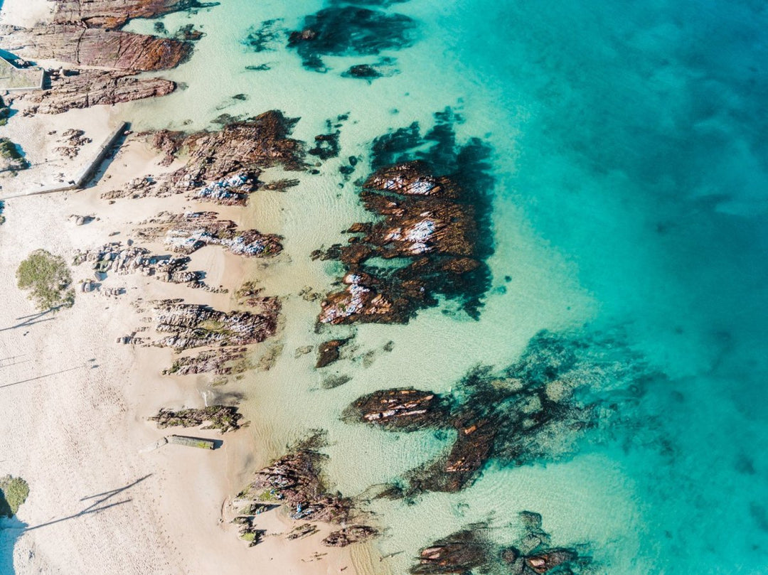 Bright turquoise blue water and rocks along Kalk Bays beach