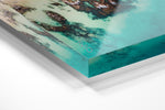 Bright turquoise blue water and rocks along Kalk Bays beach in an acrylic/perspex frame