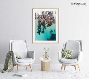 Rocks along the coast of Kalk Bay in blue calm water in a natural fine art frame