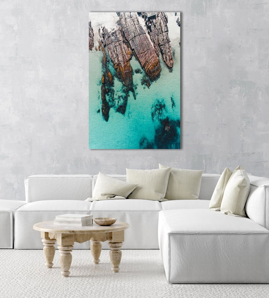 Rocks along the coast of Kalk Bay in blue calm water in a natural fine art frame