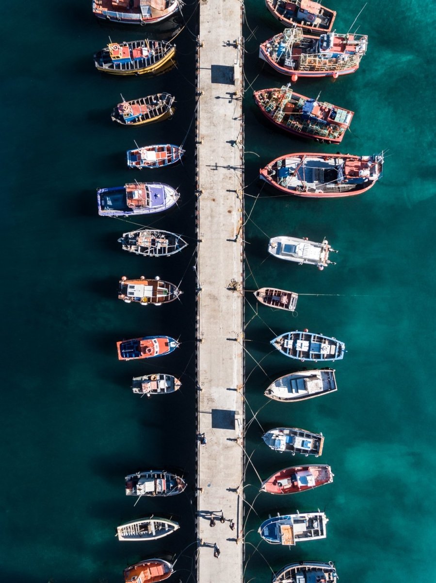 Aerial of boats docked in dark water at Kalk Bay harbour