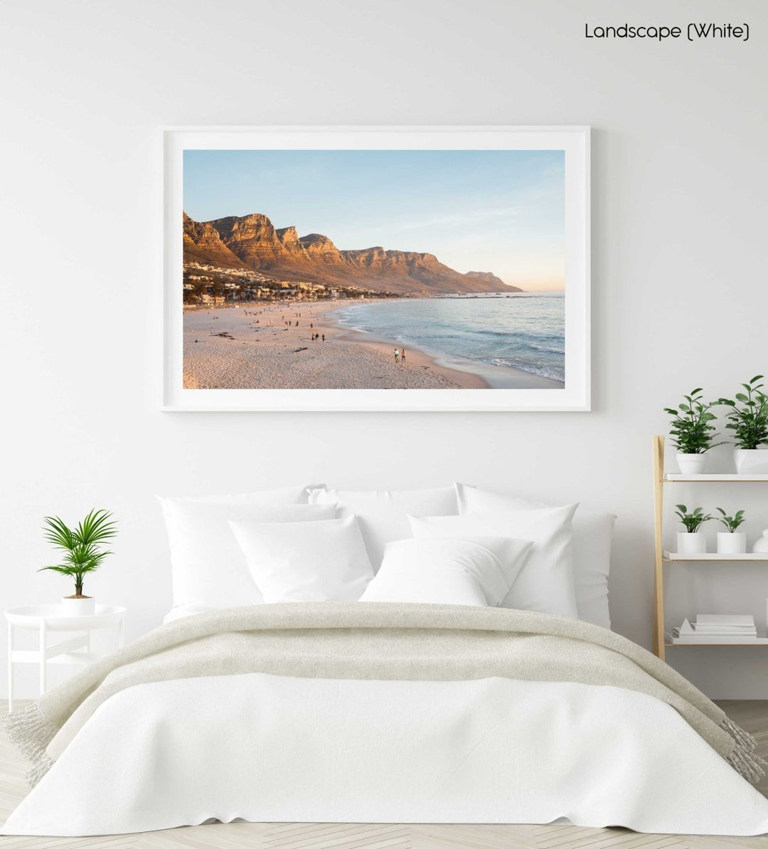 People walking along Camps Bay beach during an orange sunset in a white fine art frame