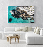 Aerial of boulders and blue sea along the coast of Simons Town in a white fine art frame