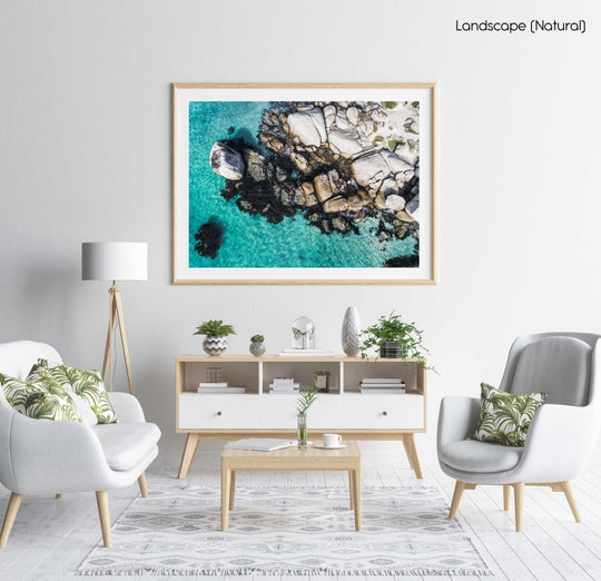 Aerial of boulders and blue sea along the coast of Simons Town in a natural fine art frame