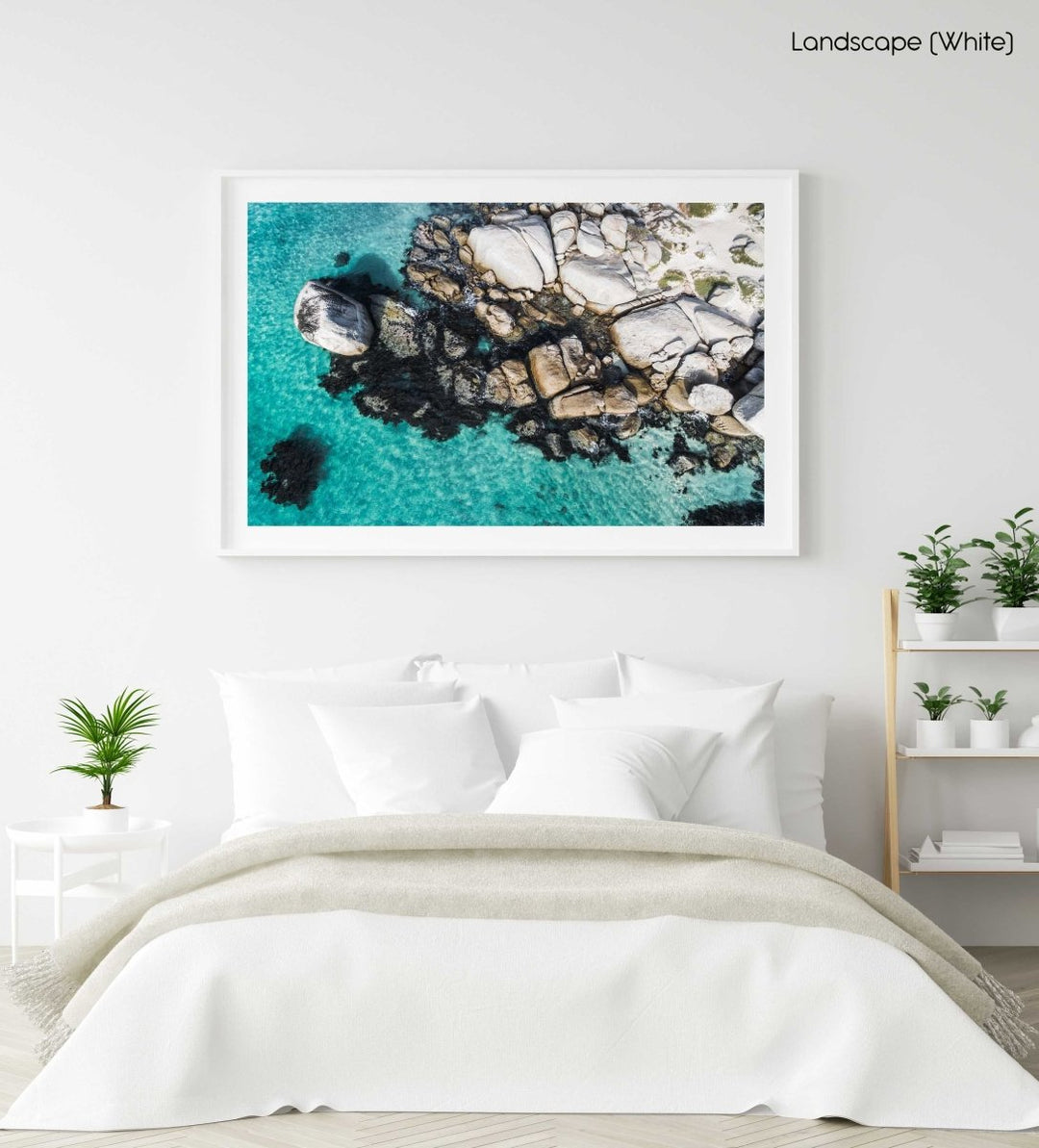 Aerial of boulders and blue sea along the coast of Simons Town in a white fine art frame