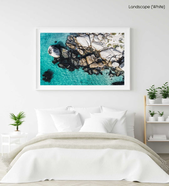 Aerial of boulders and blue sea along the coast of Simons Town in a white fine art frame