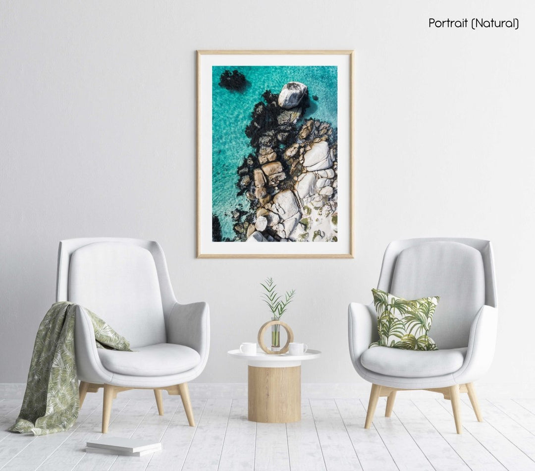 Aerial of boulders and blue sea along the coast of Simons Town in a natural fine art frame