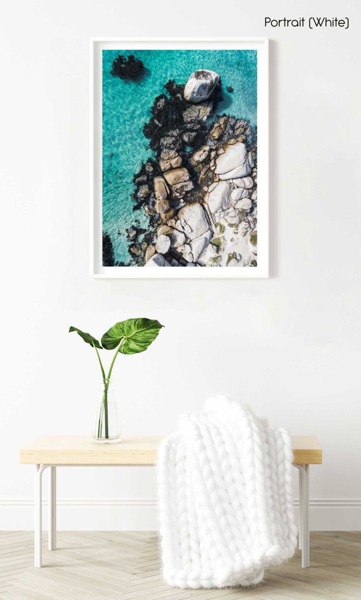 Aerial of boulders and blue sea along the coast of Simons Town in a white fine art frame