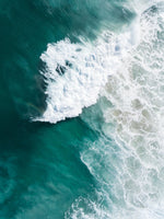 Large wave crashing at Noordhoek beach seen from above