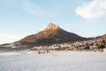 Lions Head glowing from sunset at Camps Bay beach