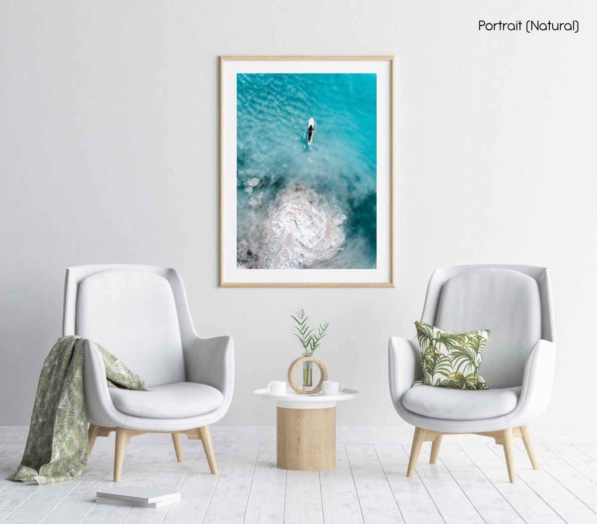 Aerial topdown of girl surfer in wetsuit paddling in blue water in a natural fine art frame