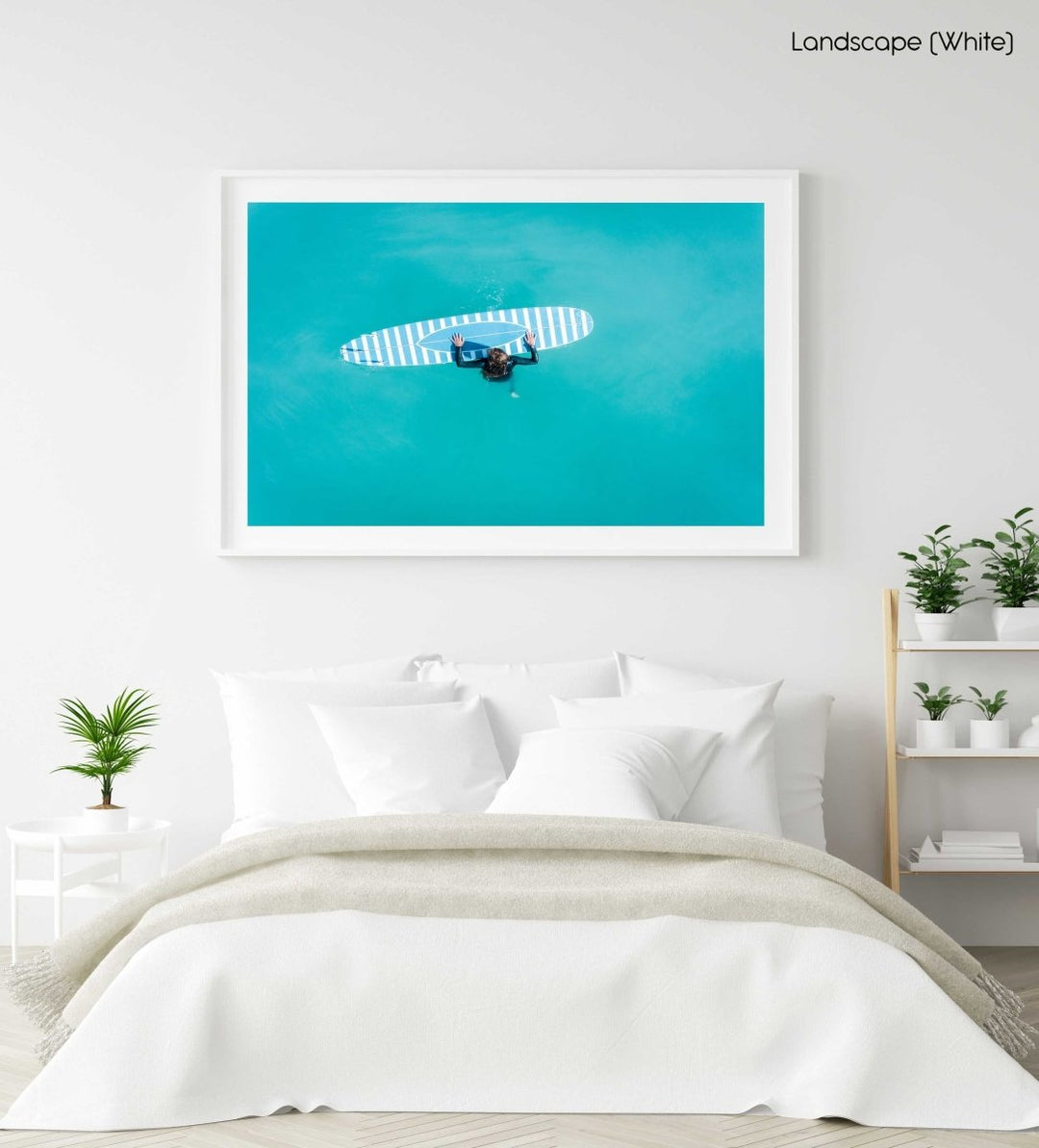 Aerial of girl holding striped surfboard in blue water in Camps Bay Beach in a white fine art frame