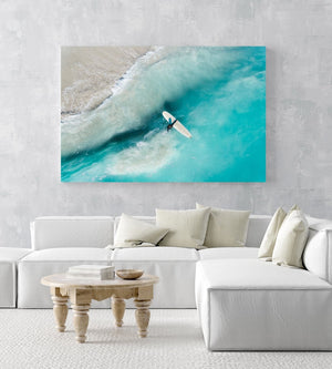 Girl walking back to shore with surfboard in blue water and waves in a white fine art frame