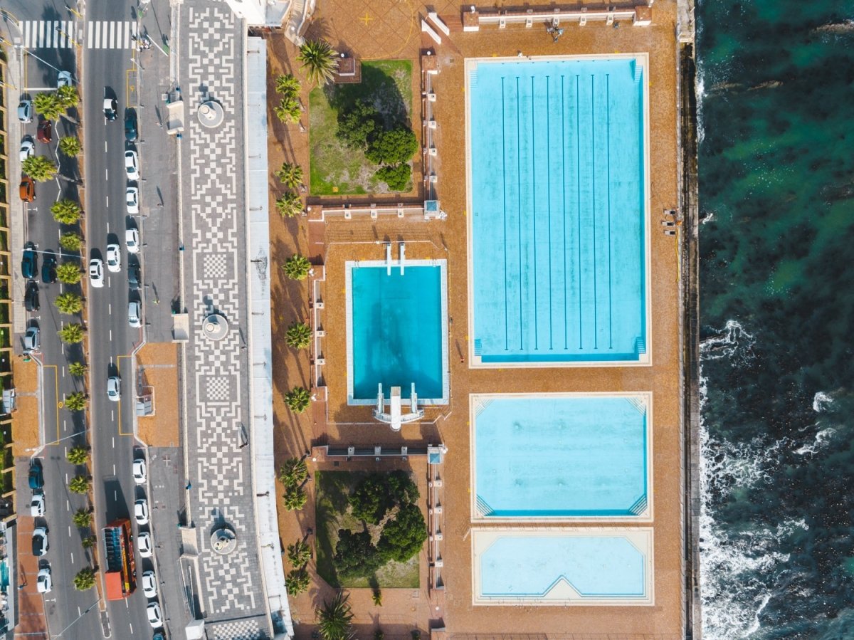 Aerial topdown of promenade pools and cars at Sea Point Cape Town