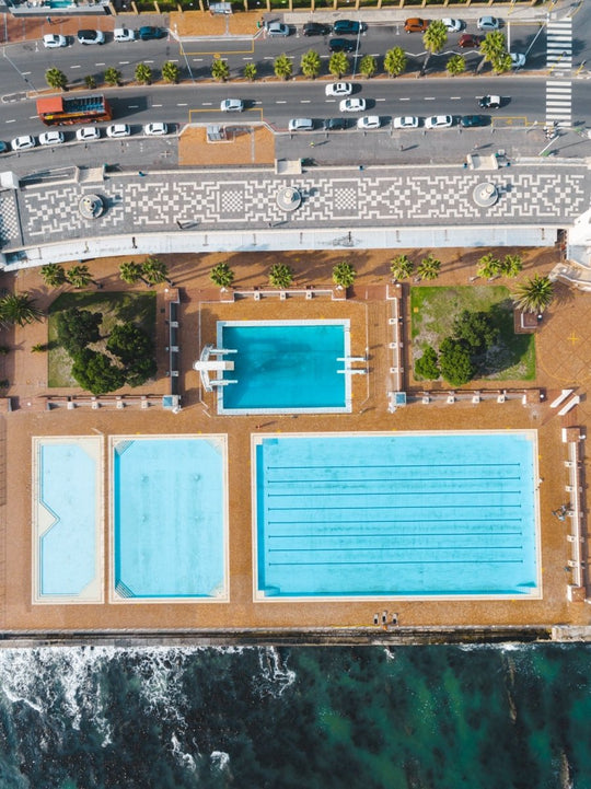 Aerial topdown of promenade pools and cars at Sea Point Cape Town