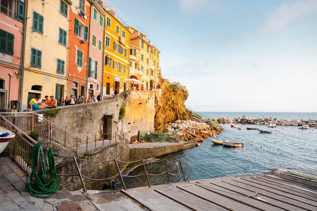 Slipway and people walking along ocean in Riomaggiore